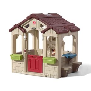 step2 charming cottage kids playhouse – outdoor playset with large windows, working doorbell, sink, and fireplace – realistic stone, faux wood finishing, and neutral color palette for backyard
