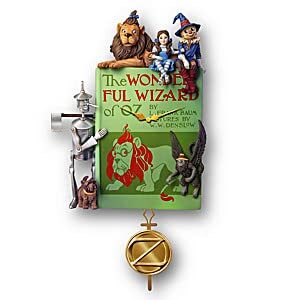 the wonderful wizard of oz fully-sculpted wall clock featuring a replica of the classic book’s original cover that doubles as the clock face with a golden oz seal as the clock pendulum
