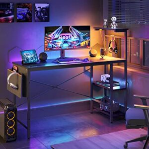 bestier gaming desk with led lights, computer desk with 4 tiers reversible shelves, 51.3 inch home office writing desk with side storage bag, hooks and height adjustable shelf (black grained)