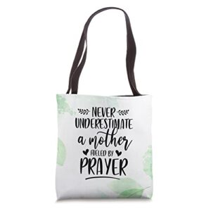 christian mom never underestimate a mother fueled by prayer tote bag