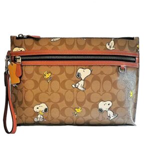 coach peanuts carry all pouch with snoopy woodstock print