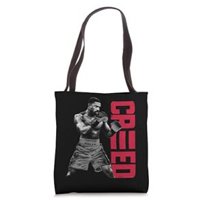 adonis creed pose with vertical logo red tote bag