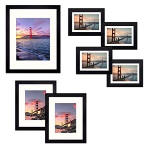 frametory, gallery wall frame set of 7 multiple sizes 11×14, 8×10, 5×7 picture frame collage with ivory color mat for prints, with real glass (black)