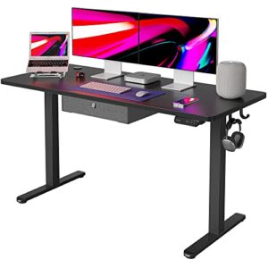 fezibo 55 x 24 inches standing desk with drawer, adjustable height electric stand up desk, sit stand home office desk, ergonomic workstation black steel frame/black tabletop