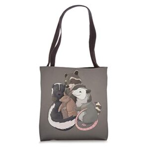 group hug – raccoon, possum, skunk, and armadillo tote bag