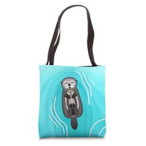mother and pup sea otters – mom holding baby otter tote bag