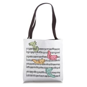 cute axolotl plays with music notes on music sheet tote bag
