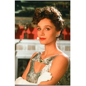 kristin scott thomas sitting lips pursed together slight smile arms crossed in front 8 x 10 inch photo