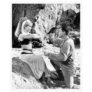 barbara eden 8 inch x10 inch photo i dream of jeannie 7 faces of dr. lao harper valley p.t.a. arms crossed w/larry hagman on left knee in sand kn