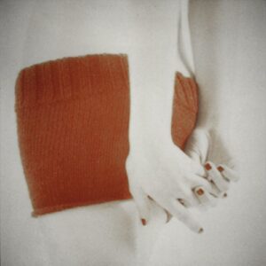 orange knit with clasped hands