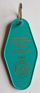 the grand budapest hotel room # 142 republic of zubrowka gbh inspired key tag teal/gold