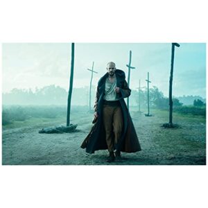 cursed (2020 season 1) gustaf skarsgard (merlin) walking, wearing cloak, stick crosses in background 8 inch by 10 inch photograph, bg