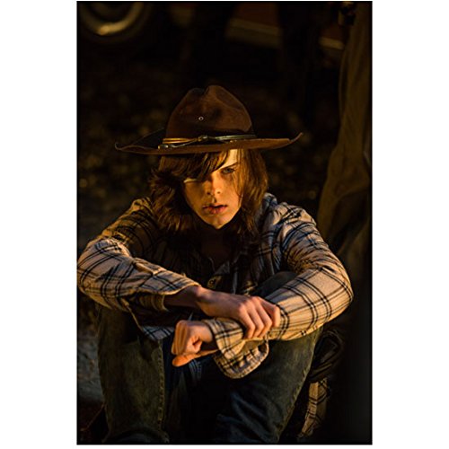 The Walking Dead Chandler Riggs as Carl sitting with arms around knees 8 x 10 Inch Photo