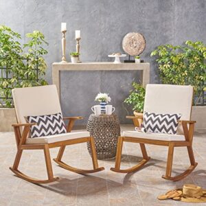 Christopher Knight Home Andy | Outdoor Acacia Wood ocking Chair with Water-Resistant (Set of 2), Teak Finish/Cream Cushion