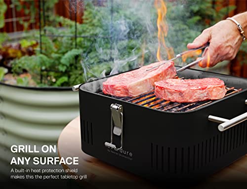 Everdure CUBE Portable Charcoal Grill, Tabletop BBQ, Perfect Tailgate, Beach, Patio, or Camping Grill, Lightweight & Compact Small Grill with Preparation Board & Food Storage Tray, Matte Black