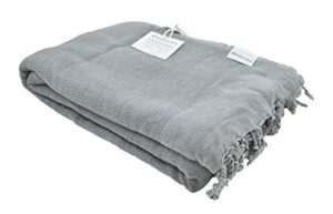 stonewashed turkish throw blanket in denim grey blue, soft, cozy and lightweight, perfect for use as a love seat or sofa throw, partical bed cover, beach blanket or yoga blanket