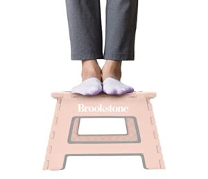brookstone bkh1100 9” folding step stool, non-slip textured grip surface, foldable space saving design, carrying handle, holds up to 300 pounds, blush