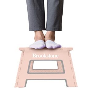 Brookstone BKH1100 9” Folding Step Stool, Non-Slip Textured Grip Surface, Foldable Space Saving Design, Carrying Handle, Holds Up to 300 Pounds, Blush