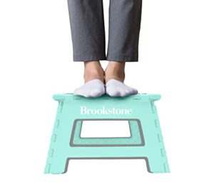 brookstone bkh1101 9” folding step stool, non-slip textured grip surface, foldable space saving design, carrying handle, holds up to 300 pounds, mint