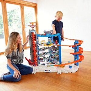 Hot Wheels Toy Car Track Set & 4 1:64 Scale Cars, Super Ultimate Garage, 3+ Ft Tall with Motorized Gorilla & Storage for 140 Cars