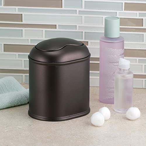 mDesign Modern Plastic Mini Wastebasket Trash Can Dispenser with Swing Lid for Bathroom Vanity Countertop or Tabletop - Dispose of Cotton Rounds, Makeup Sponges, Tissues - Bronze