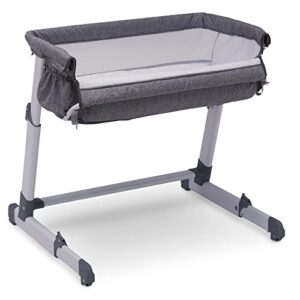 delta children simmons kids dream bedside bassinet with zip-down side wall – convenient baby sleeper with breathable mesh and adjustable heights - lightweight portable crib, grey