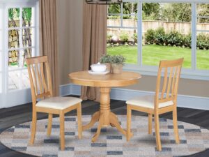 east west furniture antique 3 piece kitchen set for small spaces contains a round dining room table with pedestal and 2 faux leather upholstered chairs, 36x36 inch, oak