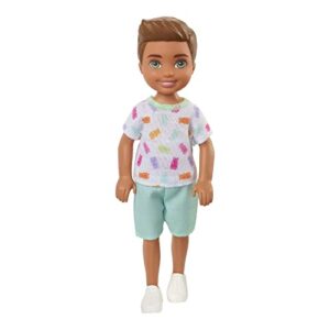 barbie chelsea doll, small boy doll with brown hair & blue eyes wearing gummy bear t-shirt, shorts & shoes