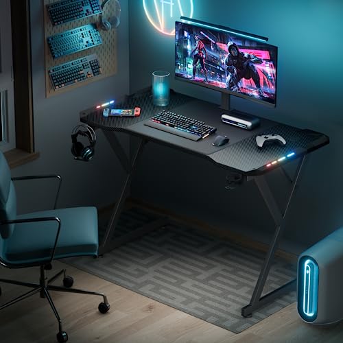 HLDIRECT 47 Inch Gaming Desk with LED Lights, Ergonomic Computer Gaming Table with Carbon Fibre Surface, Sturdy PC Workstation Desk for Gaming and Home Office with Headphone Hook, Cup Holder, Black