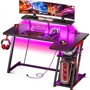 motpk l shaped gaming desk with led lights, corner gaming computer desk 47inch with power outlets, gaming table with pc storage shelf, gamer desk with monitor shelf, carbon fiber texture, black