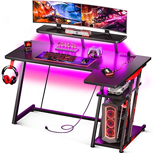 MOTPK L Shaped Gaming Desk with LED Lights, Corner Gaming Computer Desk 47inch with Power Outlets, Gaming Table with PC Storage Shelf, Gamer Desk with Monitor Shelf, Carbon Fiber Texture, Black