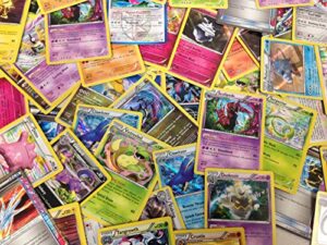 50 assorted pokemon cards with bonus holo foils