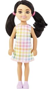barbie chelsea doll, small doll with black hair in pigtails & brown eyes wearing removable plaid dress & pink shoes