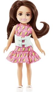 barbie chelsea doll, small doll with brace for scoliosis spine curvature, brunette wearing pink lightning bolt dress