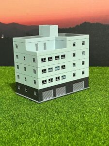 n scale train railway scene with model irregular apartment building - 1:160