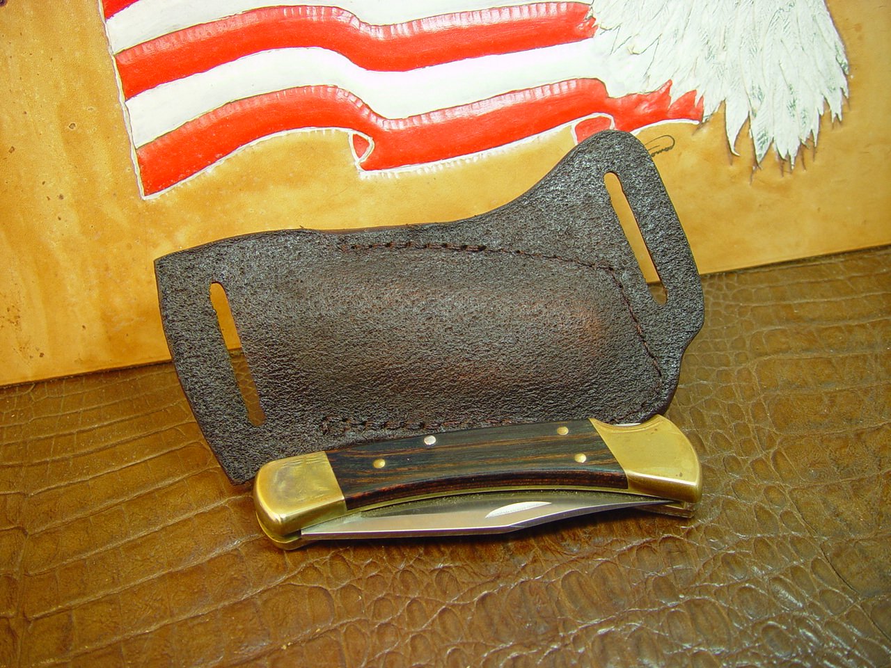 Custom left hand cross draw knife sheath for a buck 110 knife. The sheath is made out of buffalo hide leather hand tooled with a basket weave pattern.