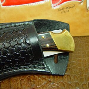 Buck Custom Left Hand Cross Draw Knife Sheath for a 110 Knife. The Sheath is Made Out of Buffalo Hide Leather Hand Tooled with a Basket Weave Pattern.