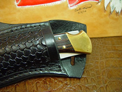 Buck Custom Left Hand Cross Draw Knife Sheath for a 110 Knife. The Sheath is Made Out of Buffalo Hide Leather Hand Tooled with a Basket Weave Pattern.