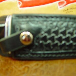 Custom Right-hand Leather knife sheath for the Buck 119 dyed black. Made with Authentic Buffalo Hide Leather and has round basket-weave tooling with strap. Sheath ONLY!!!!