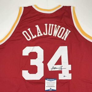 Autographed/Signed Hakeem Olajuwon Houston Red Basketball Jersey Beckett BAS COA