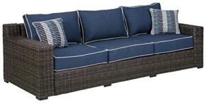 signature design by ashley grasson lane outdoor patio wicker sofa with cushion and 2 pillows, brown & blue