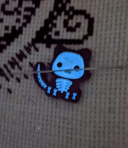 glow in the dark skeleton kitty needle minder