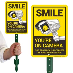 smartsign 10x7 inch “smile you’re on camera, this property is protected by video surveillance” yard sign with 18 inch stake, 40 mil aluminum, laminated engineer grade reflective, multicolor, set of 1