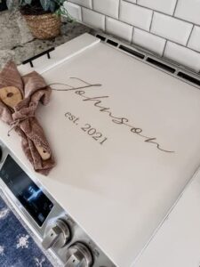 josephine thomas home personalized noodle board last name + est date in soft ivory, lightly distressed, stove cover