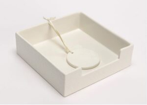 white ceramic napkin holder with weight, dinner, party, cocktail napkins to 7x7 inches. plaza collection.