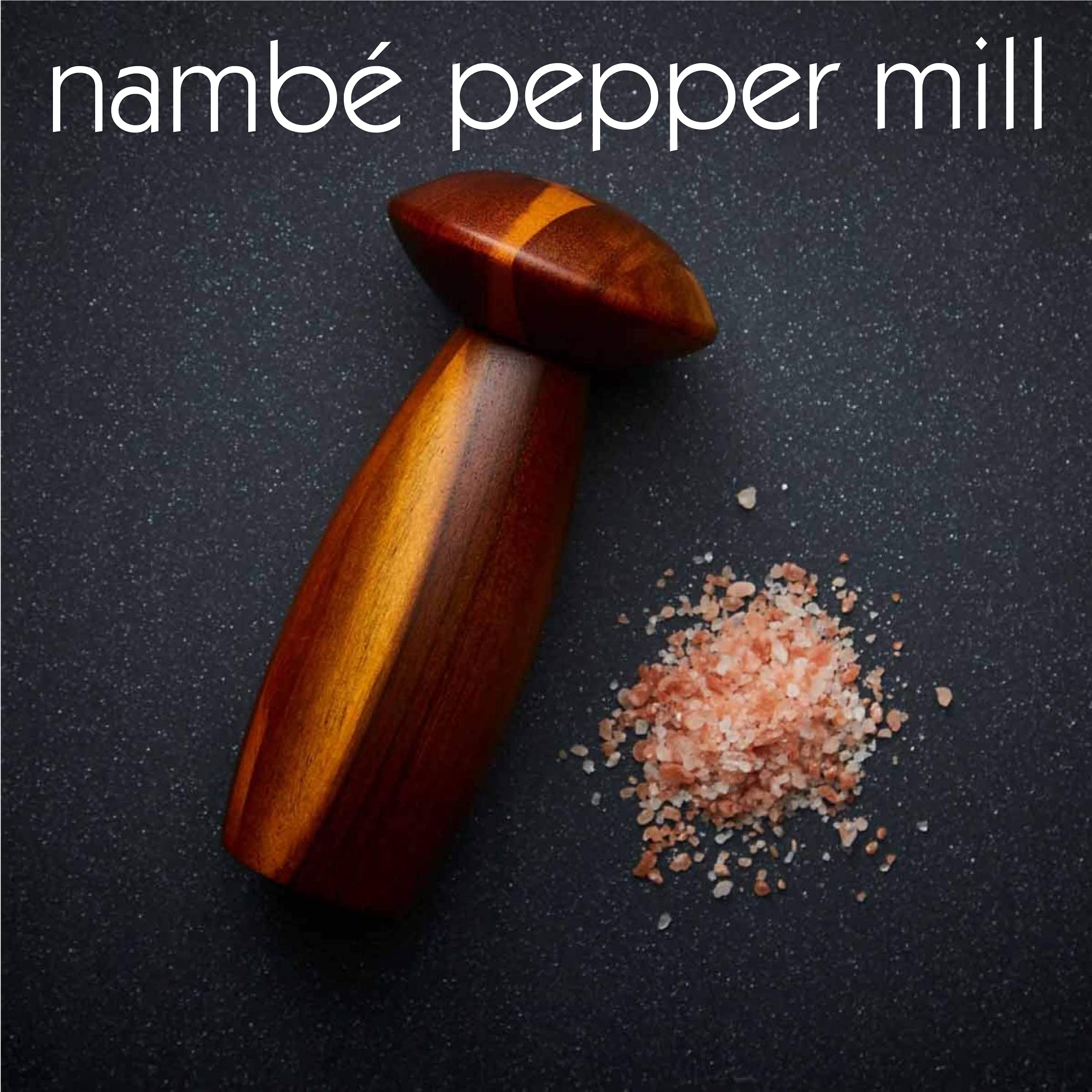 Nambe - Gourmet Collection - Contour Pepper Mill - Measures at 3" x 3.5" x 7" - Made with Acacia Wood and Ceramic Mechanism - Designed by Lou Henry