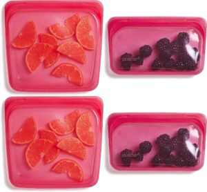 stasher silicone reusable storage bag, 4-pack lunch/travel (raspberry) | food meal prep storage container | lunch, travel, makeup, gym bag | freezer, oven, microwave, dishwasher safe, leakproof