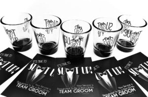 5 groomsmen shot glasses (1.75 oz) & 5 team groom proposal cards as a bachelor party gift idea with suit up & drink up text & graphics.