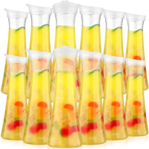 12 pcs water carafe with flip tab lid 34oz clear plastic water juice pitcher heavy duty drink containers jugs for fridge for mimosa bar, brunch, cold water, juice, wine, milk, iced tea, lemonade