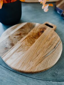 round charcuterie serving board with handle, handmade in the usa with maple hardwood.